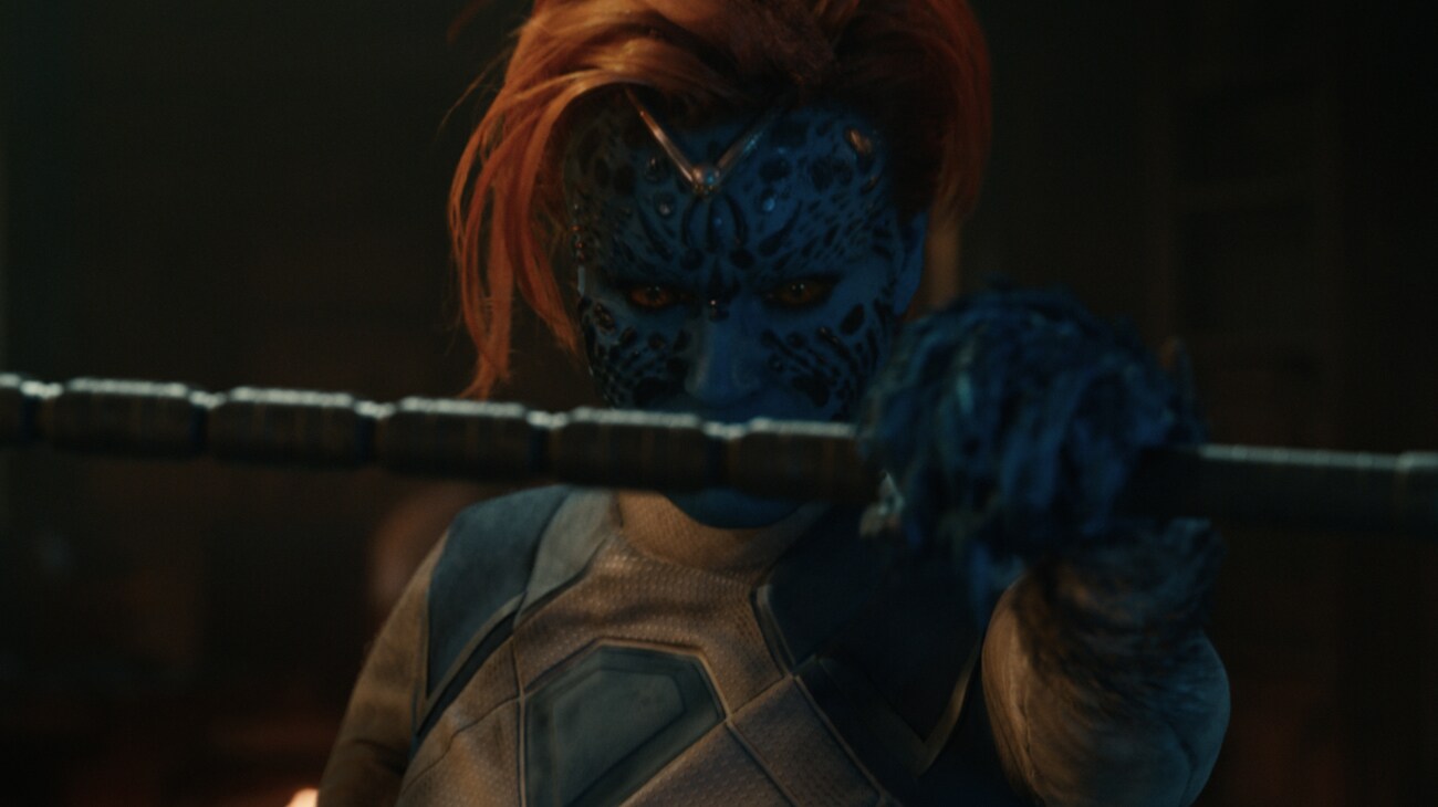 A blue-skinned warrior holds a staff